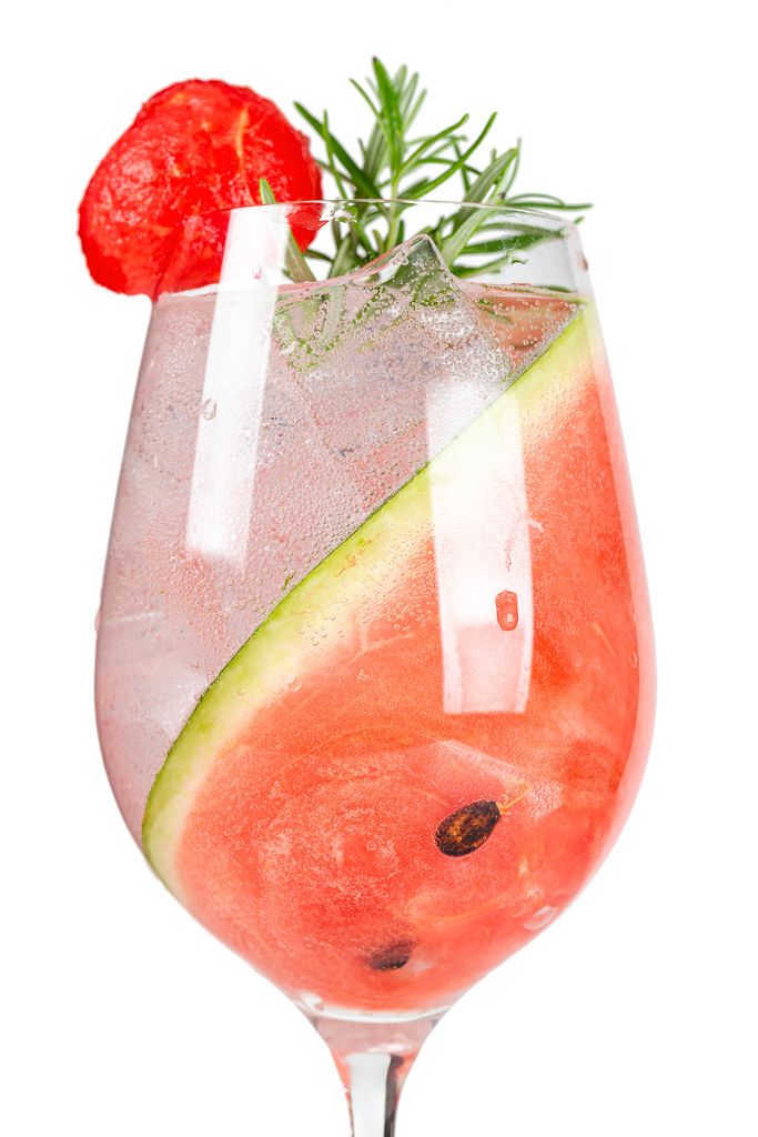 Watermelon summer cocktail with ice and rosemary
