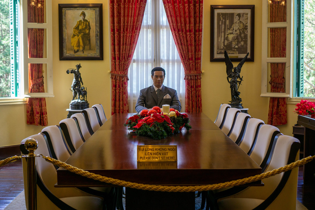 Wax Figure of Final Emperor of the Nguyen Dynasty Bao Dai sitting on a Table in a Conference Room inside the King Palace in Da Lat, Vietnam