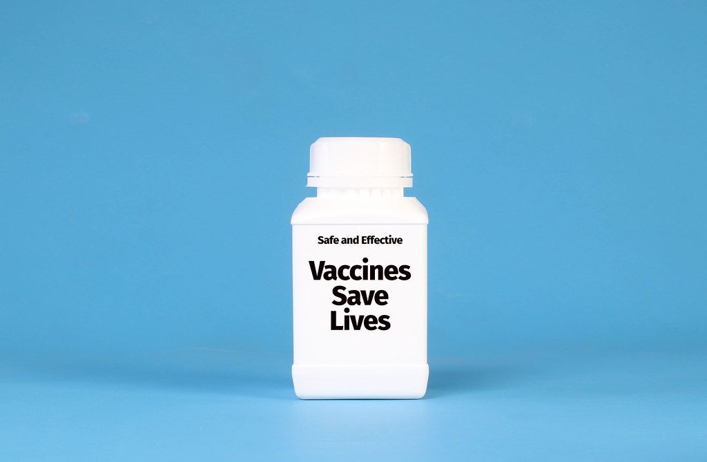 White bottle with Vaccines Save Lives text on blue background