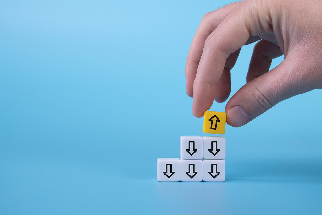 White cubes with down arrows and one yellow cube with arrow up