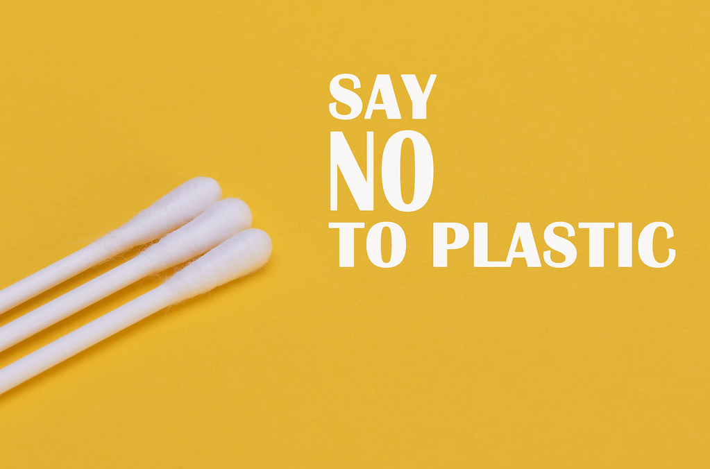 White ear sticks on a yellow background with Say no to plastic text