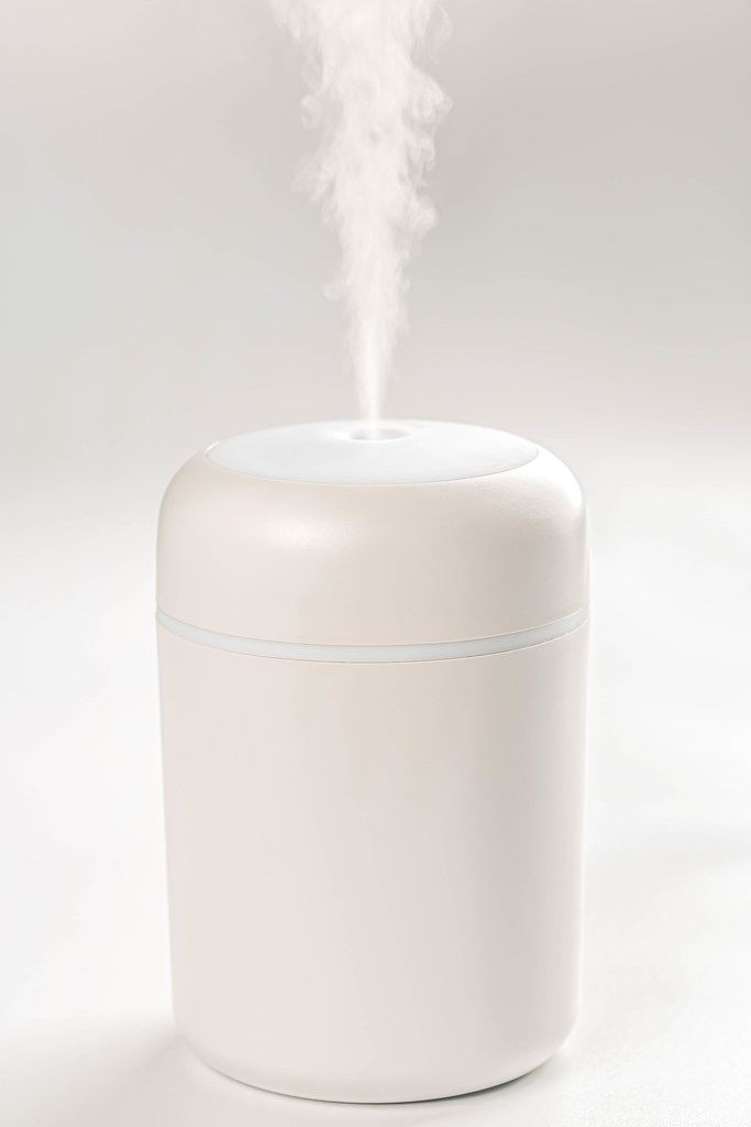 White humidifier with escaping steam