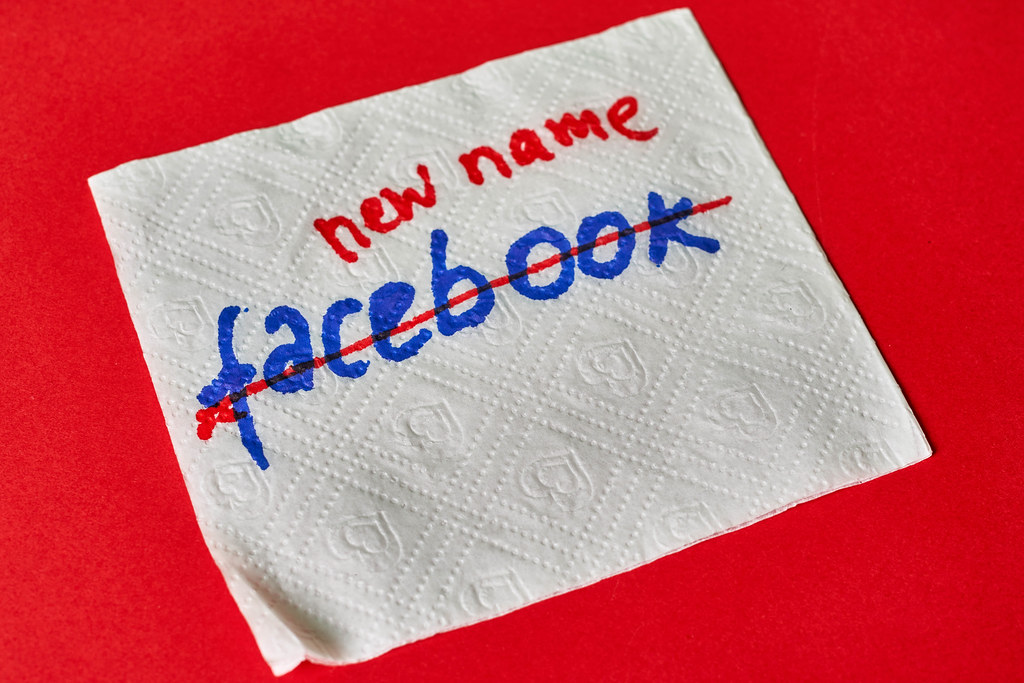 White napkin with handwritten text Facebook and crossed with red. Concept of Facebook name change