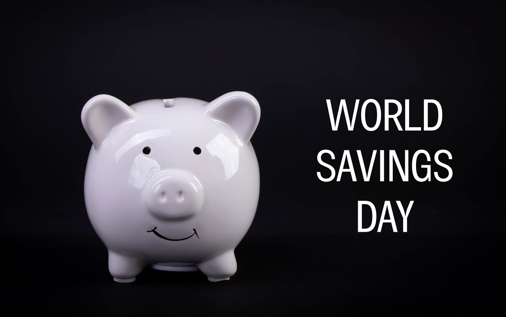 White piggybank with World Savings Day text on black background