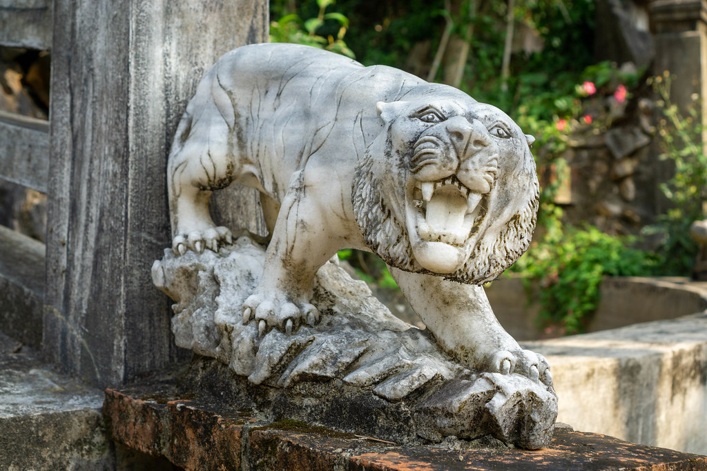 White Tiger Statue on the Beginning of a Wooden Bridge at the Marble Mountains in Danang, Vietnam