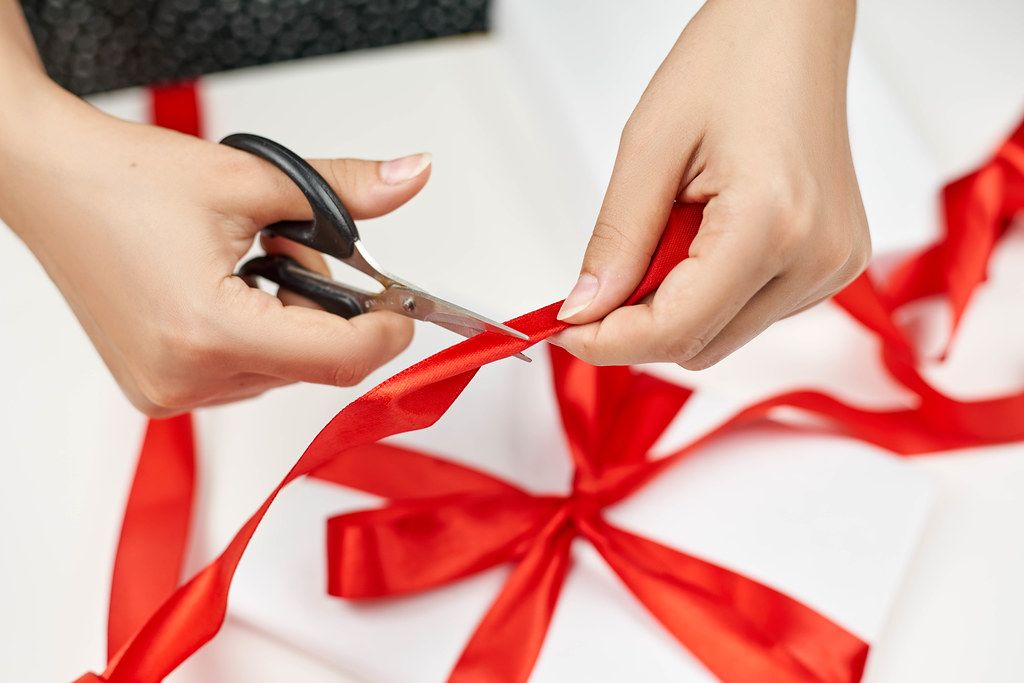 Woman finishing wrapping New Year gift