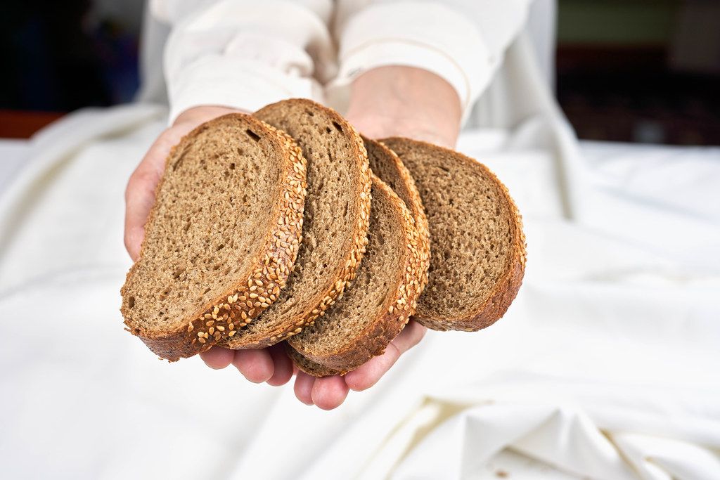 Woman holding in hands sourdough bread slices