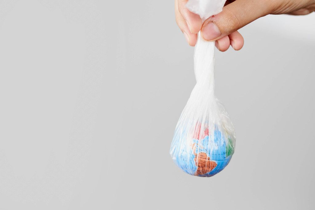 Woman holds the Earth in plastic bag. concepts of environmental and ecological problems, plastic pollution and climate change issues