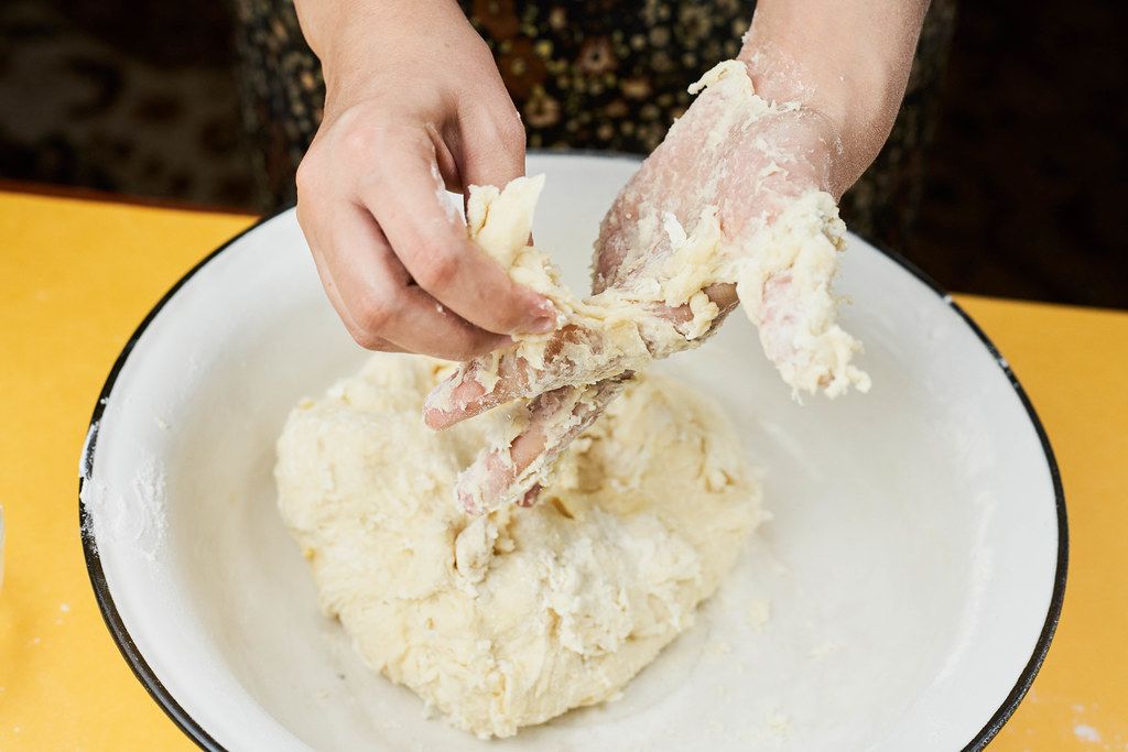 Woman kneading the dough