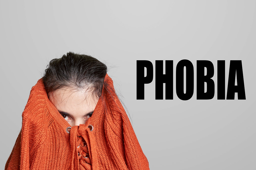 Woman with phobia hiding her head