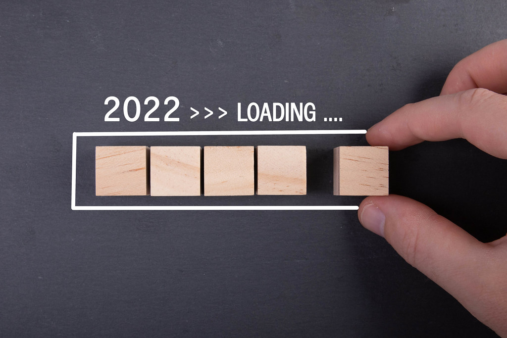 Wooden blocks in loading bar for New Year 2022