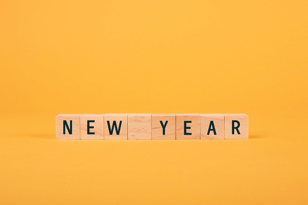 Wooden blocks with New Year text on yellow background
