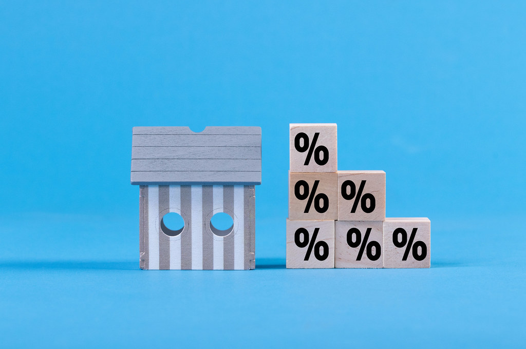 Wooden blocks with percentage sign and miniature house