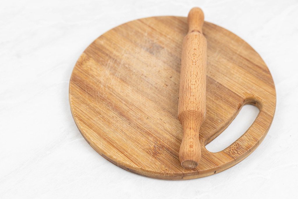 Wooden Rolling Pin on the round wooden board