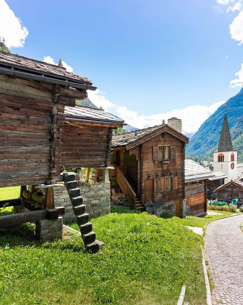 Wooden shed on Pilars with tiny stairs leading to the entrance in Swiss village