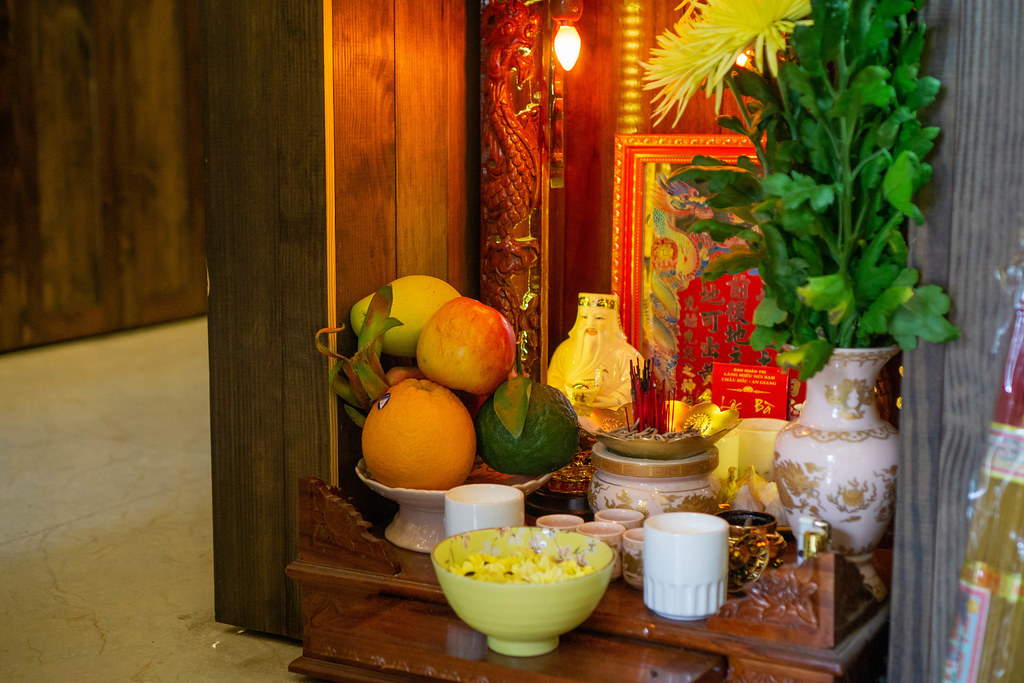 Worship Altar in a Cafe in Vietnam with Fruits, Incense, Liquor, Flowers and other Offerrngs to wish for Good Business