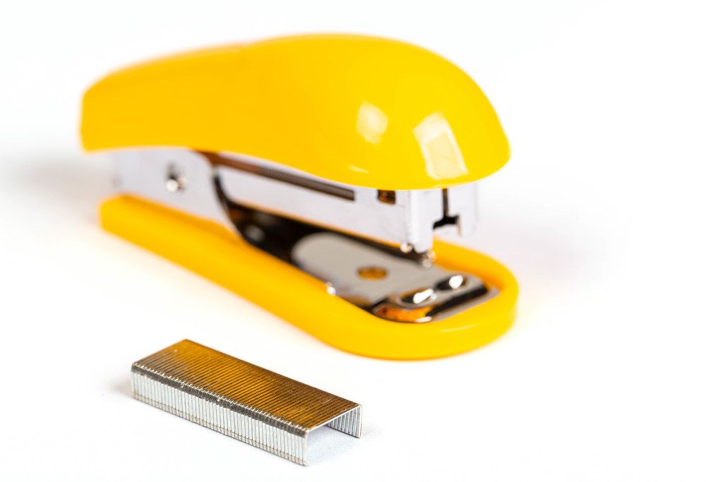 Yellow stapler and staples - office stationery