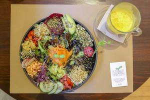 "Ensalada del Sol" at Petit Brot Restaurant in Barcelona, Spain, with vegetables, sauerkraut sprouts, marinated mushroom & pink hummus