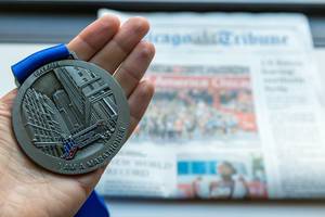"I am a marathoner" Medaille from Chicago Marathon 10.13.2019, with local daily newspaper in the background