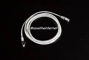 #savetheinternet text with white internet cable on black background