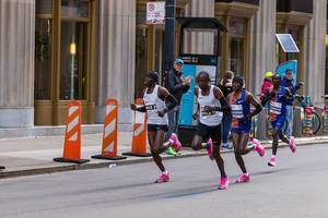 2019 Chicago Marathon winner, Kenyan Lawrence Cherono and his fellow national Dickson Chumba, who ranked 7th, preceded by pacers during the race in Downtown Chicago
