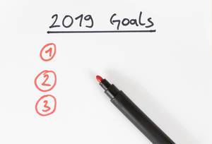 2019 Goals Yearly resolution with a red pen on paper