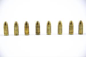 9mm bullets standing next to each other on white Background