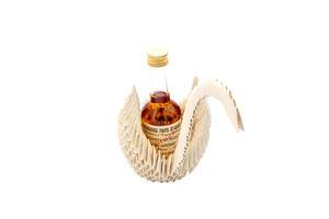 A bottle of calvados in origami of white swan