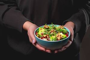 A bowl of fresh healthy food in women