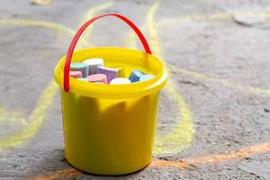 A bucket of colored chalk for drawing on the asphalt (Flip 2019)