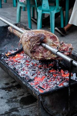 A giant beef portion being grilled
