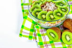 A good and healthy Breakfast - cereal and fresh fruit kiwi