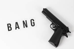 A gun with a bang text