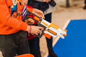 A Kid Holding Toy Nerf Rifle