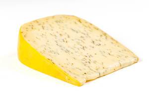 A piece of Dutch cheese with herbs and garlic on a white background (Flip 2020)