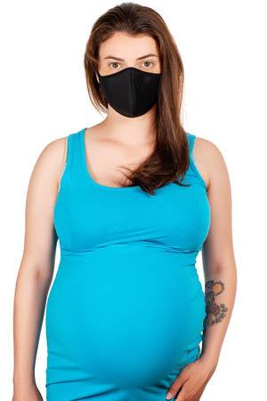 A pregnant woman in a black medical mask. Concept of health care and protection of yourself and your child
