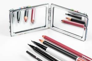 A set of cosmetics is reflected in the mirror. The concept of makeup