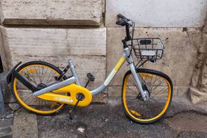 A sharing bike - rental bicycle with a twisted tire