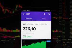 A smartphone displays the American Tower Corporation market value