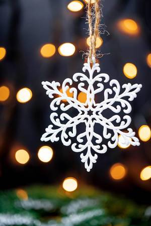 A white snowflake with dark background and lights
