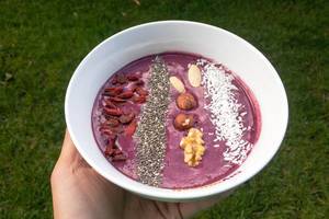 Acai-Bowl with dried fruit, nuts and coconut rasps