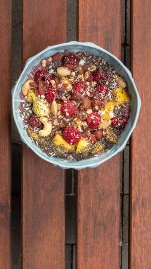 Acai Bowl with quinoa, raspberry, mango, cashew nuts and dried fruit
