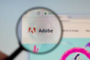 Adobe logo on a computer screen with a magnifying glass