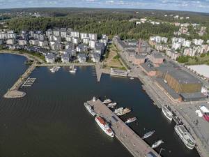 Aerial photo shows a route section for the Finnish triathlon event "Ironman 70.3" at the coast of the port district of Lahti, with yachts and motor boats
