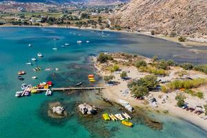 Aerial photo shows the rocky coast of Kolimbithres on Paros, and colorful pedal boats in the Aegean Sea