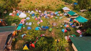 Aerial shot of campers preparing their tents