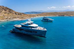 Aerial shot of luxurious yachts and 32 meters Numarine yacht Q.M. on the blue sea in the Aegean Sea, at Cape Korakas on Paros, Greece