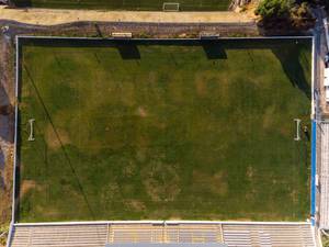 Aerial view drone shot of a football court in Almada Lisbon