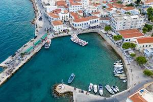 Aerial view of a small bay and busy streets at Spetses, Greece, with water taxis for island hopping