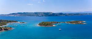 Aerial view of Chenesa Island to Spetses, Greece, in the blue sea of the Argolic Gulf